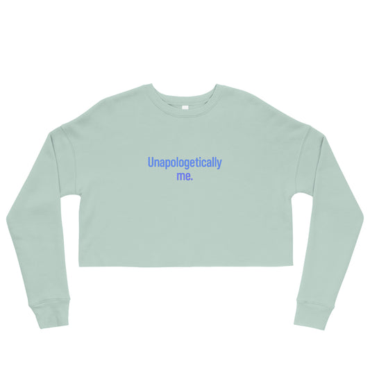 Sage green cropped crewneck sweatshirt with the phrase “Unapologetically me.” printed in light blue centered on the chest.
