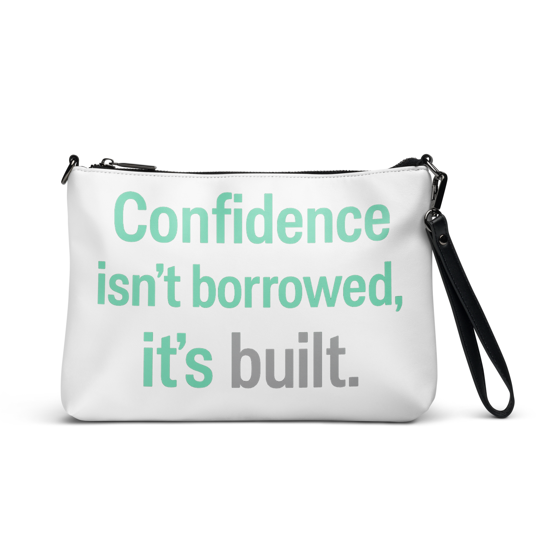 White crossbody bag with the quote “Confidence isn’t borrowed, it’s built.” printed in mint green and gray.