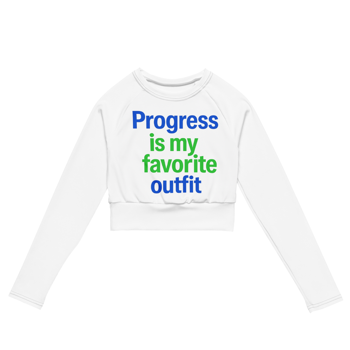 White cropped long sleeve shirt with colorful text reading “Progress is my favorite outfit” in blue and green.
