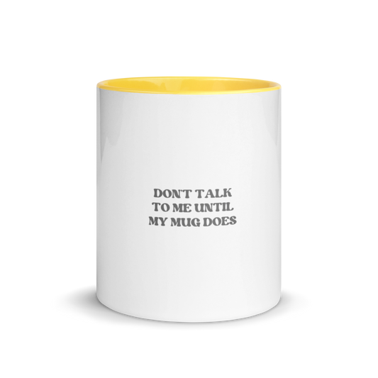 White ceramic mug with yellow inside and black printed text: “DON’T TALK TO ME UNTIL MY MUG DOES.”
