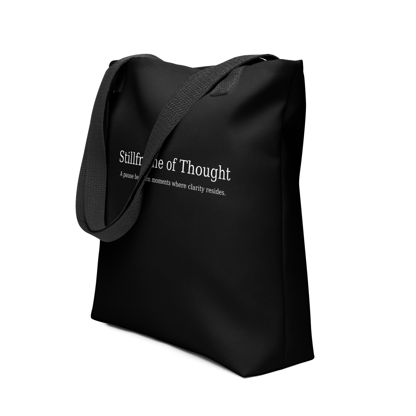 Black tote bag with white text reading “Stillframe of Thought” shown with matching black handles.