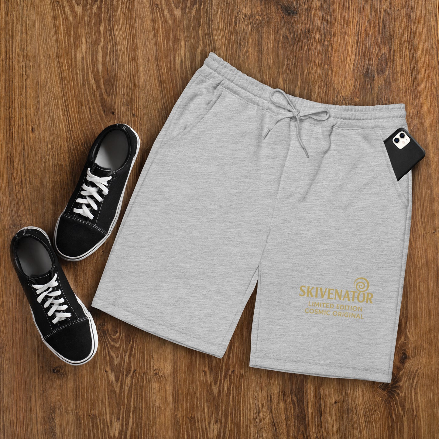 Men’s grey fleece shorts with gold SKIVENATOR™ emblem, side pockets, and relaxed fit – part of the limited-edition Cosmic Originals collection.